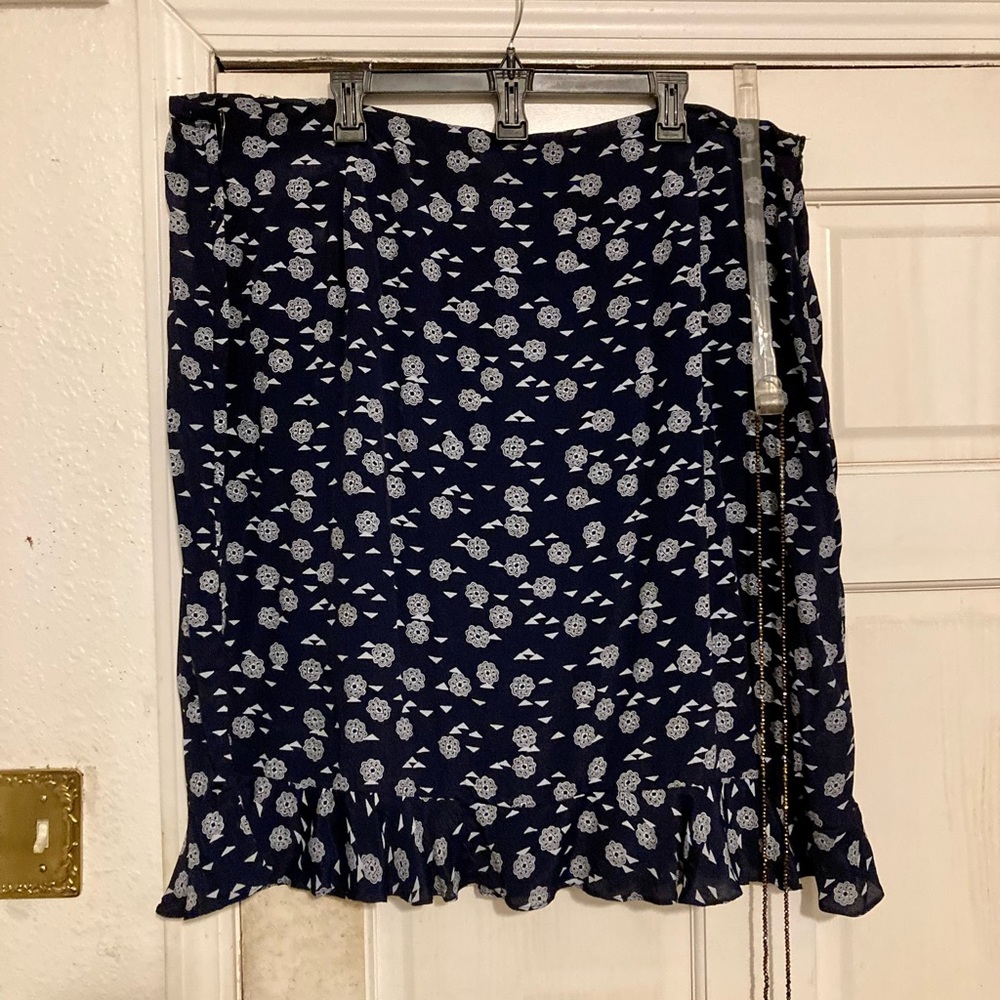 Navy and white print rayon skirt with hem ruffle.